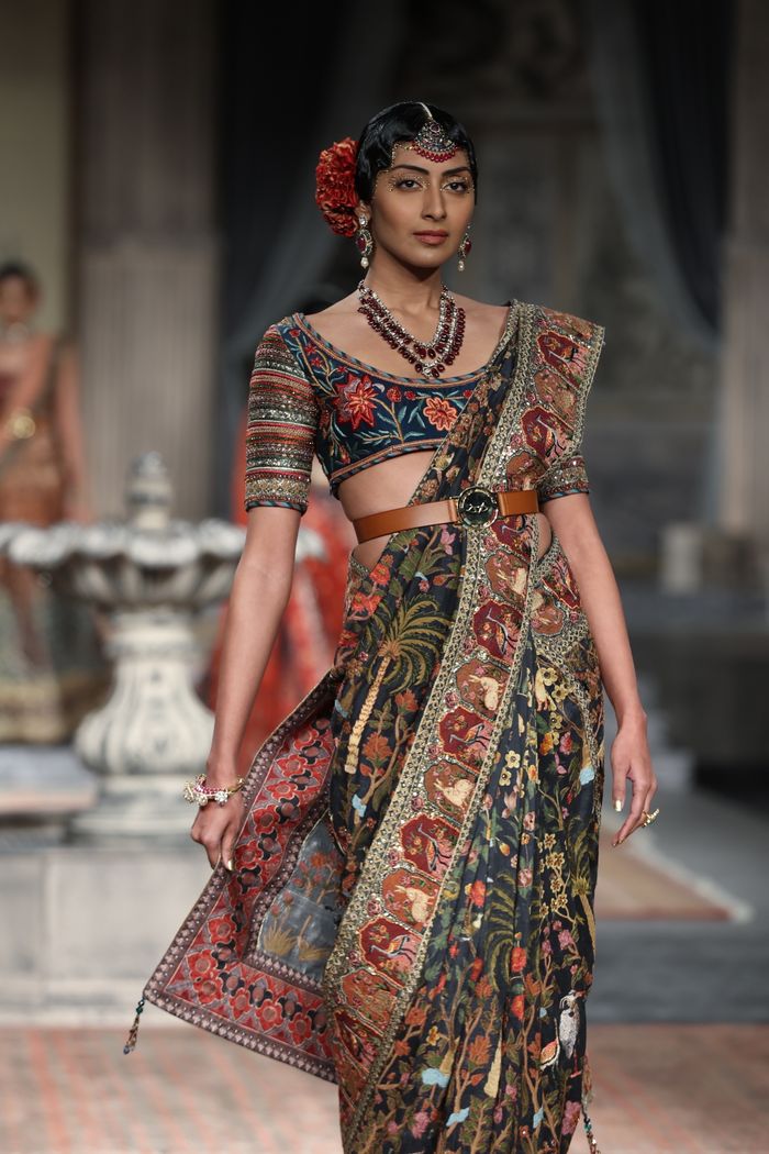 Portrait of a fashion model showcasing a traditional Indian saree during a fashion shoot.
